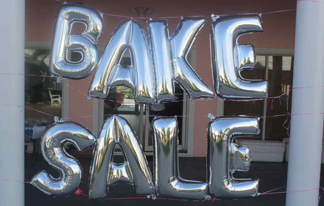 PTA bake sale balloon letters on school building